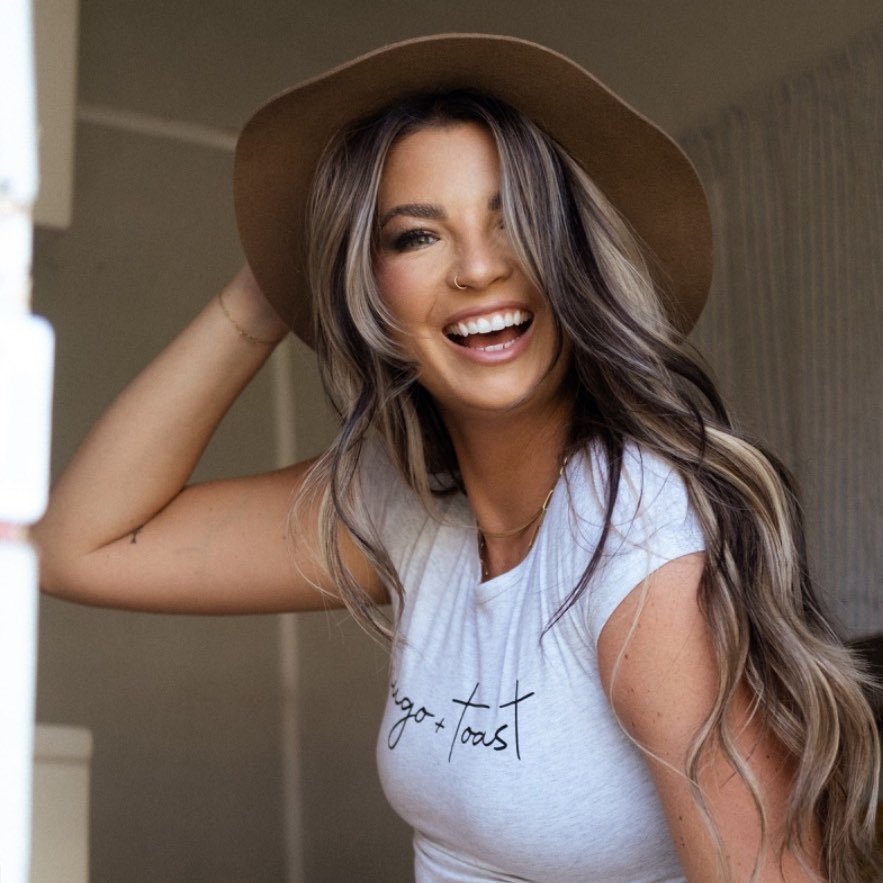 Jess Moskaluke smiling with a hat on.