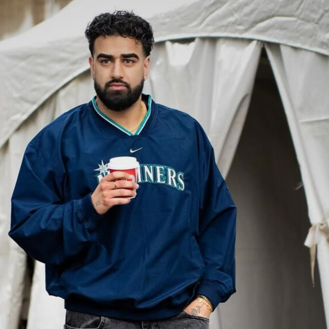 Musician Jshn holding coffee cup.