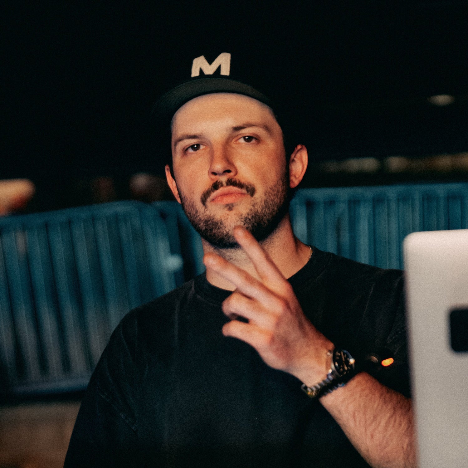 Tyler Carino wearing a hat and doing the peace sign with his hand.