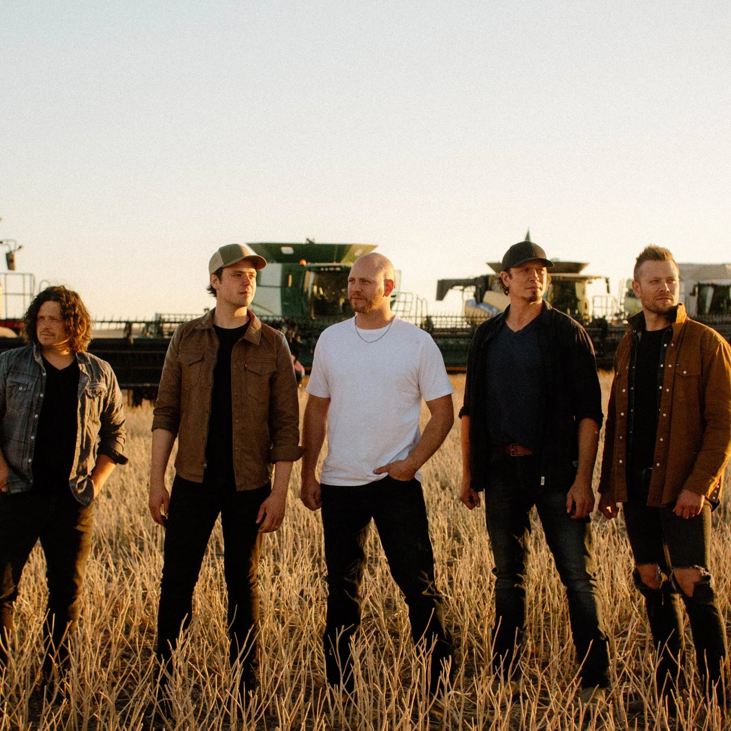 Hunter Brothers standing in a wheat field.