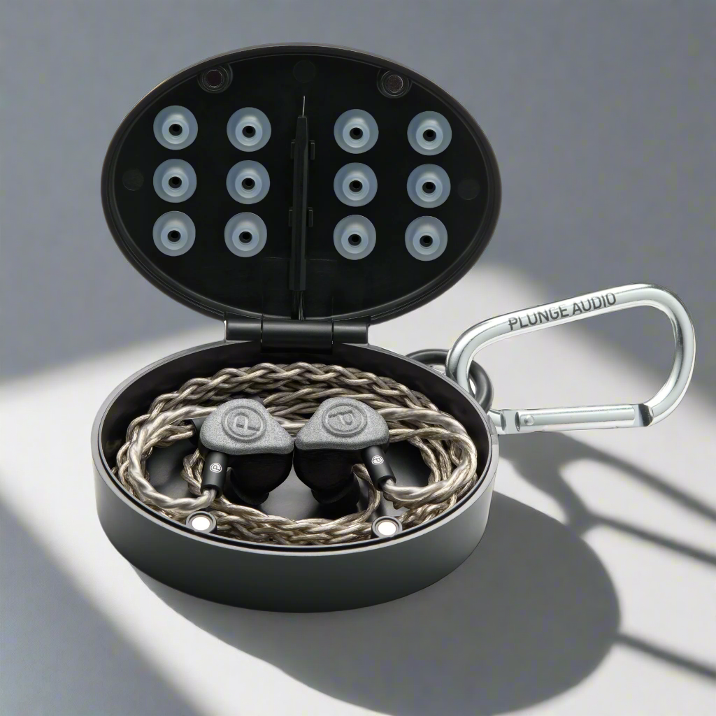 Unity IEMs in an open black oval case.