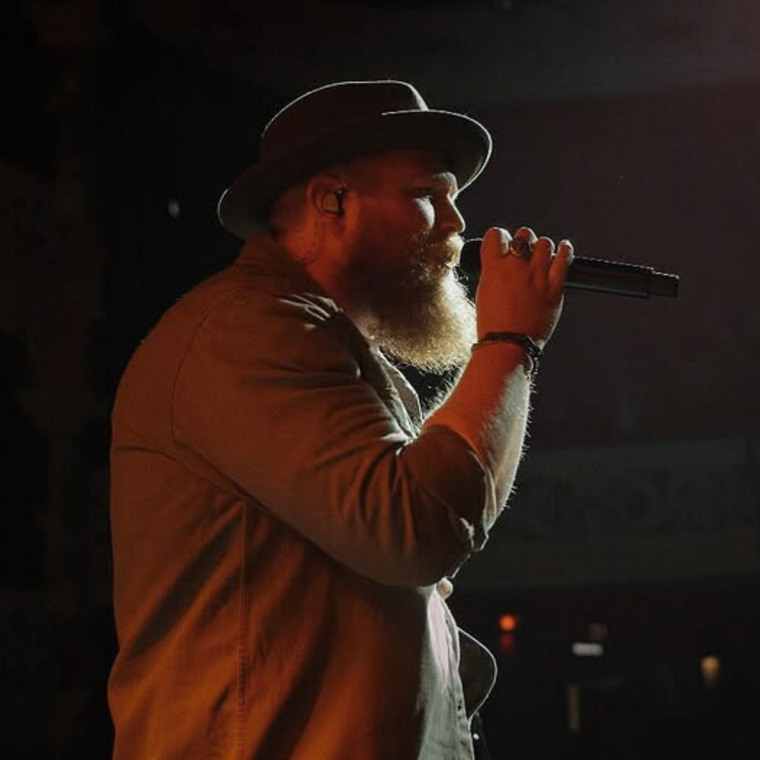 Tyler Braden wearing Unity IEMs sings into a mic.