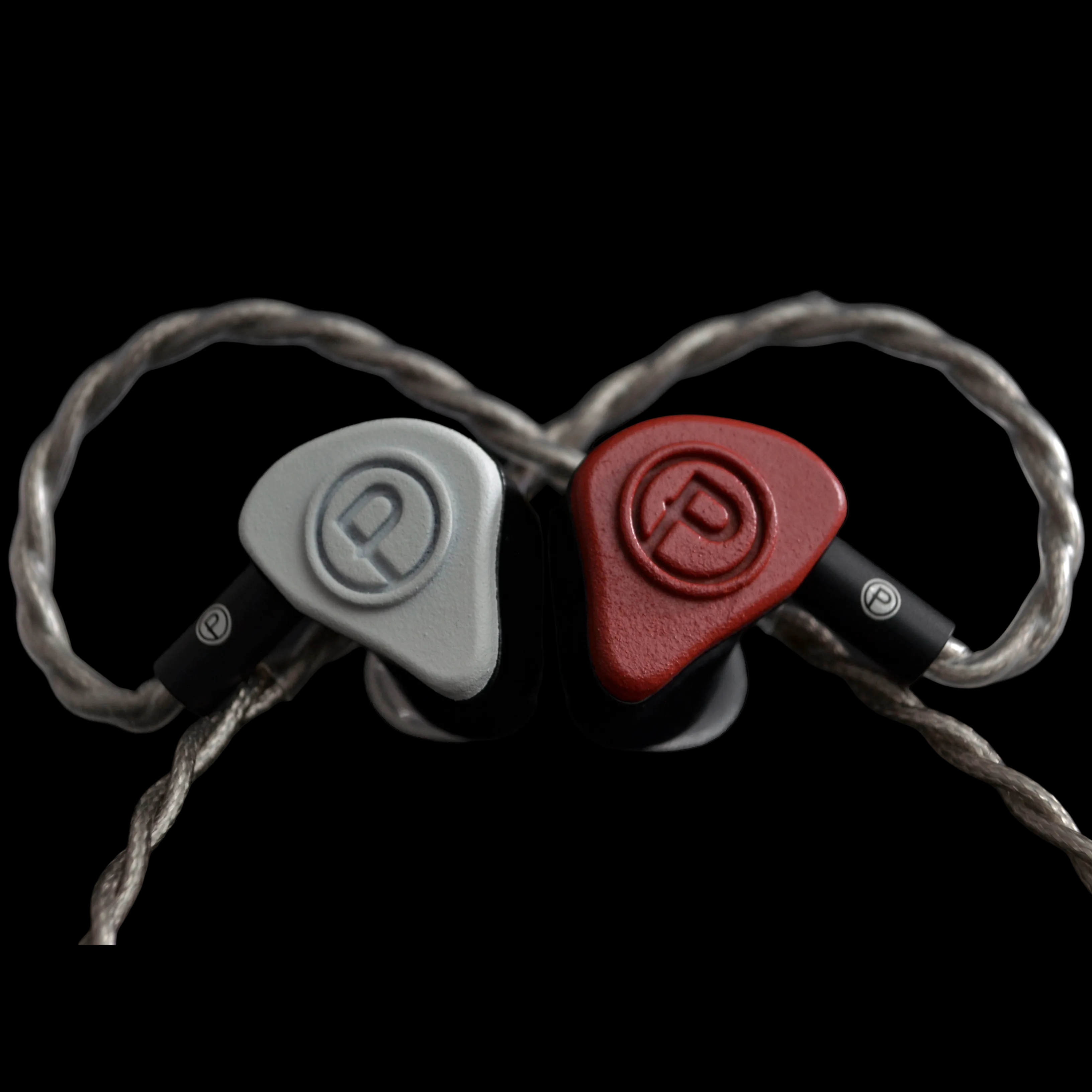 Pair of red and white in-ear monitors on a black background