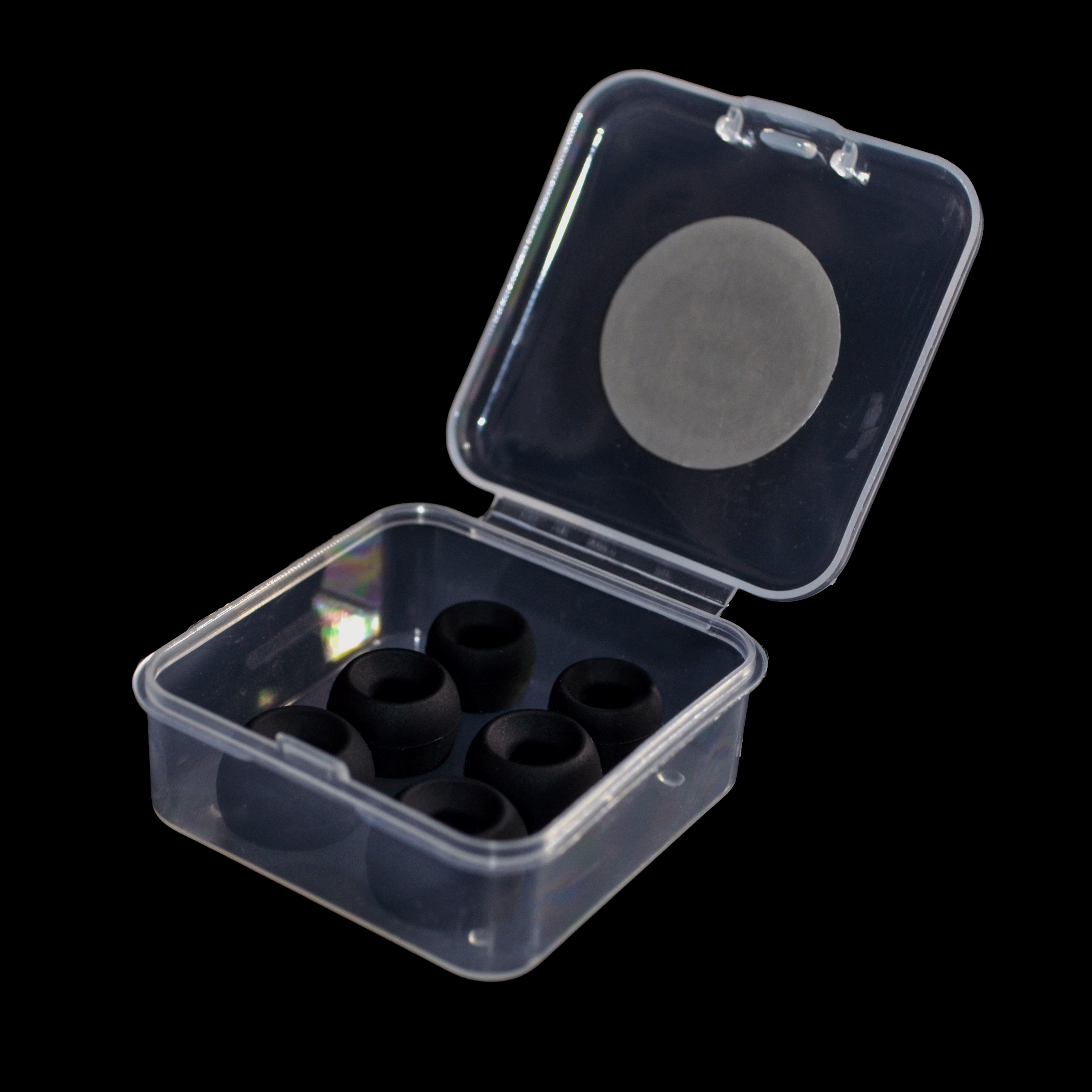 Clear plastic container with black IEM tips on a black background