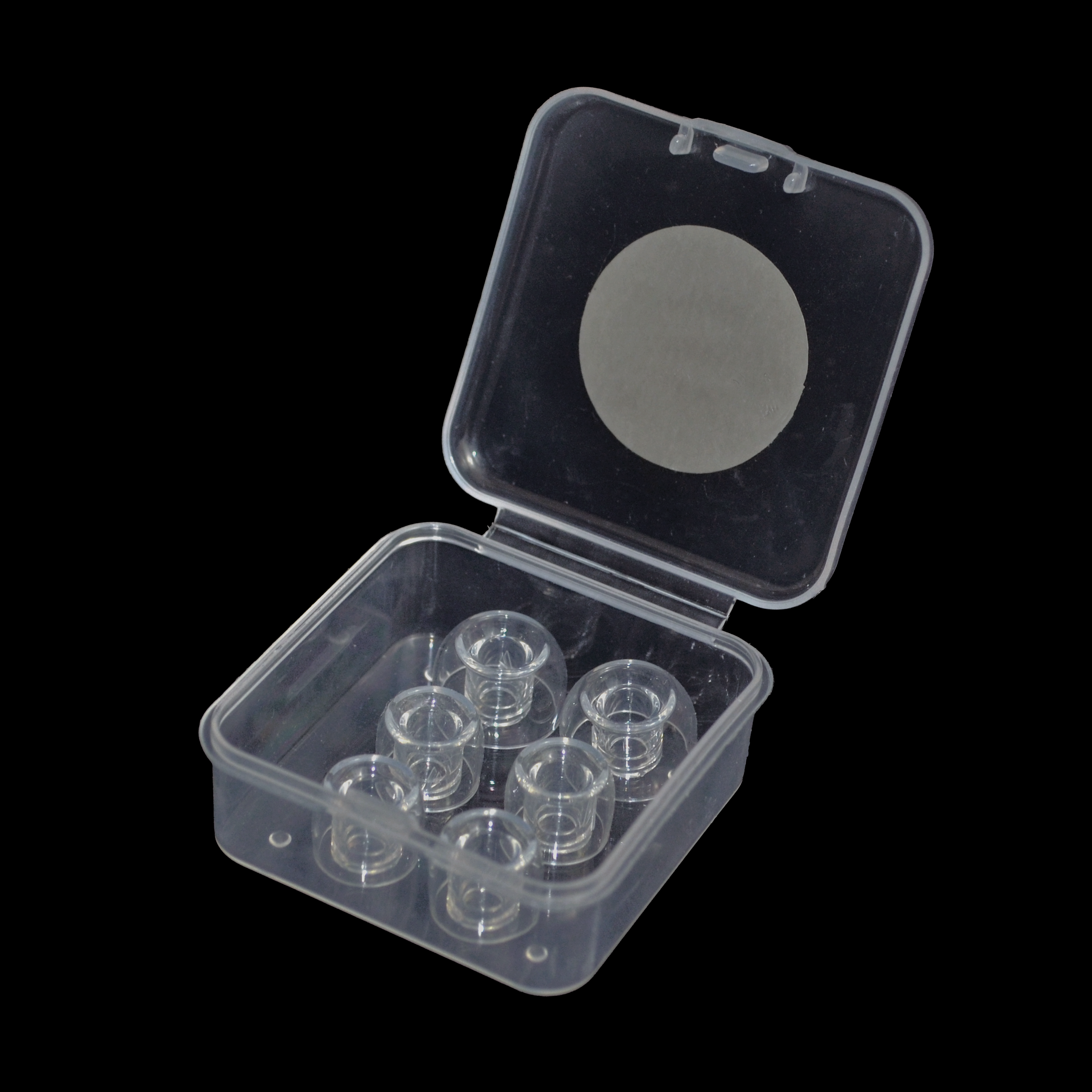 Clear plastic container with six small clear IEM tips on a black background