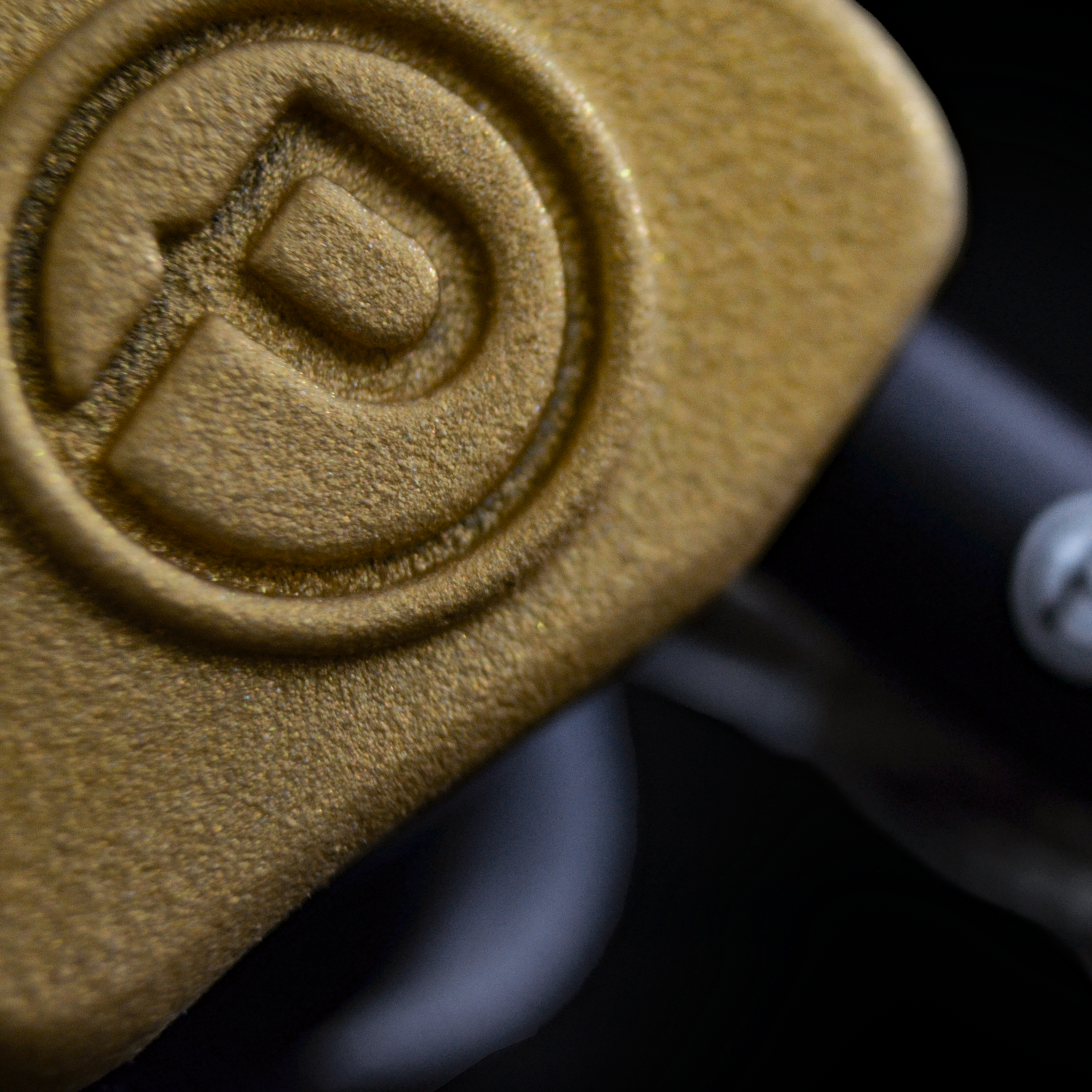 Close-up of a gold IEM
