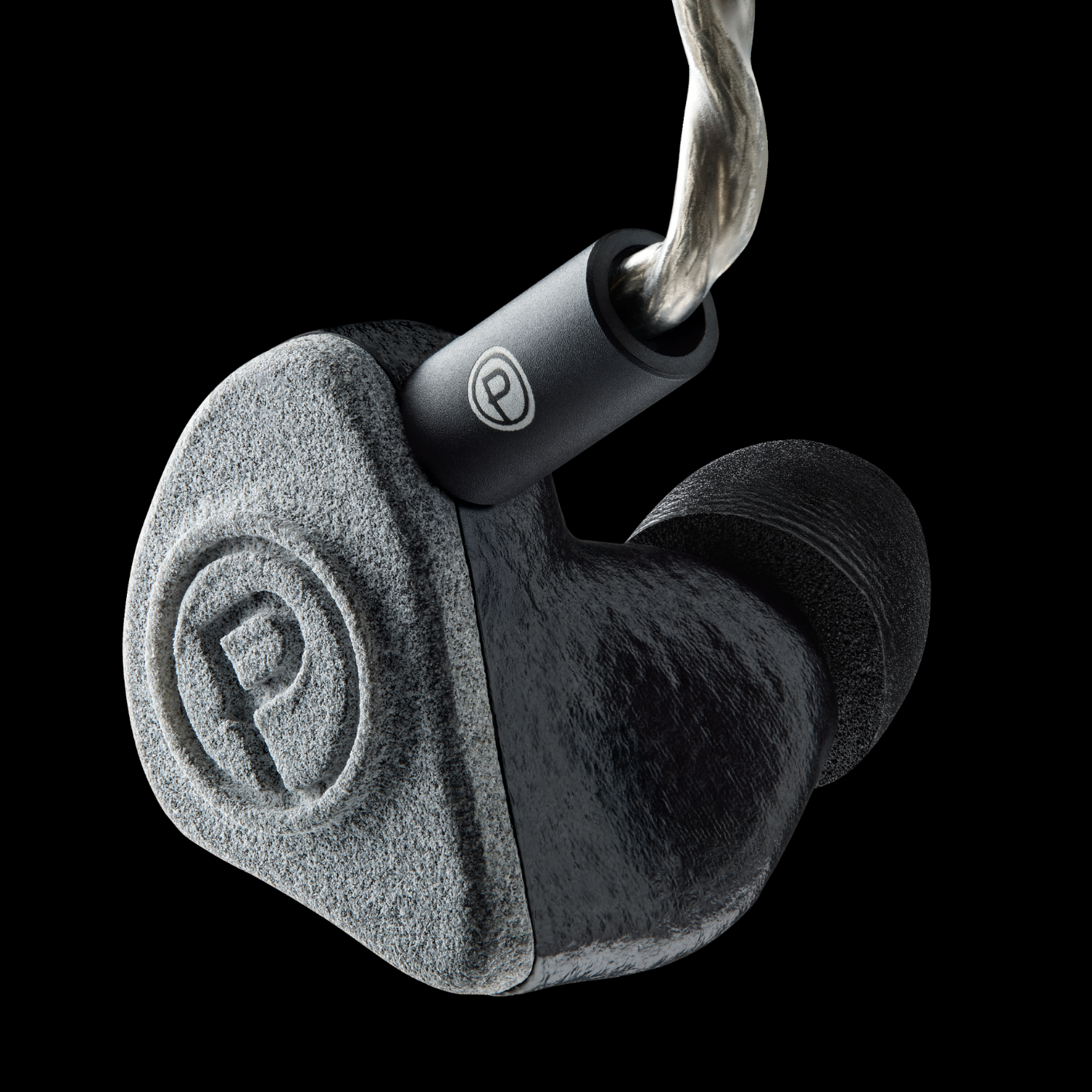 A single in-ear headphone with a gray shell and a black logo, featuring a braided cable.