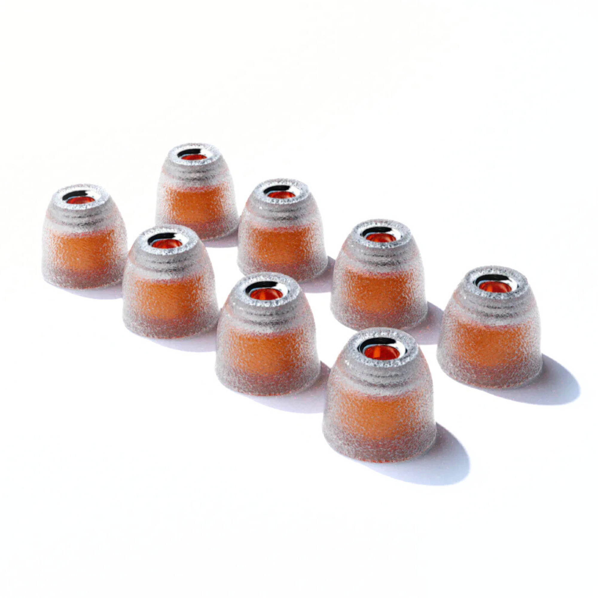 Set of eight small IEM tips with orange centers on a white background