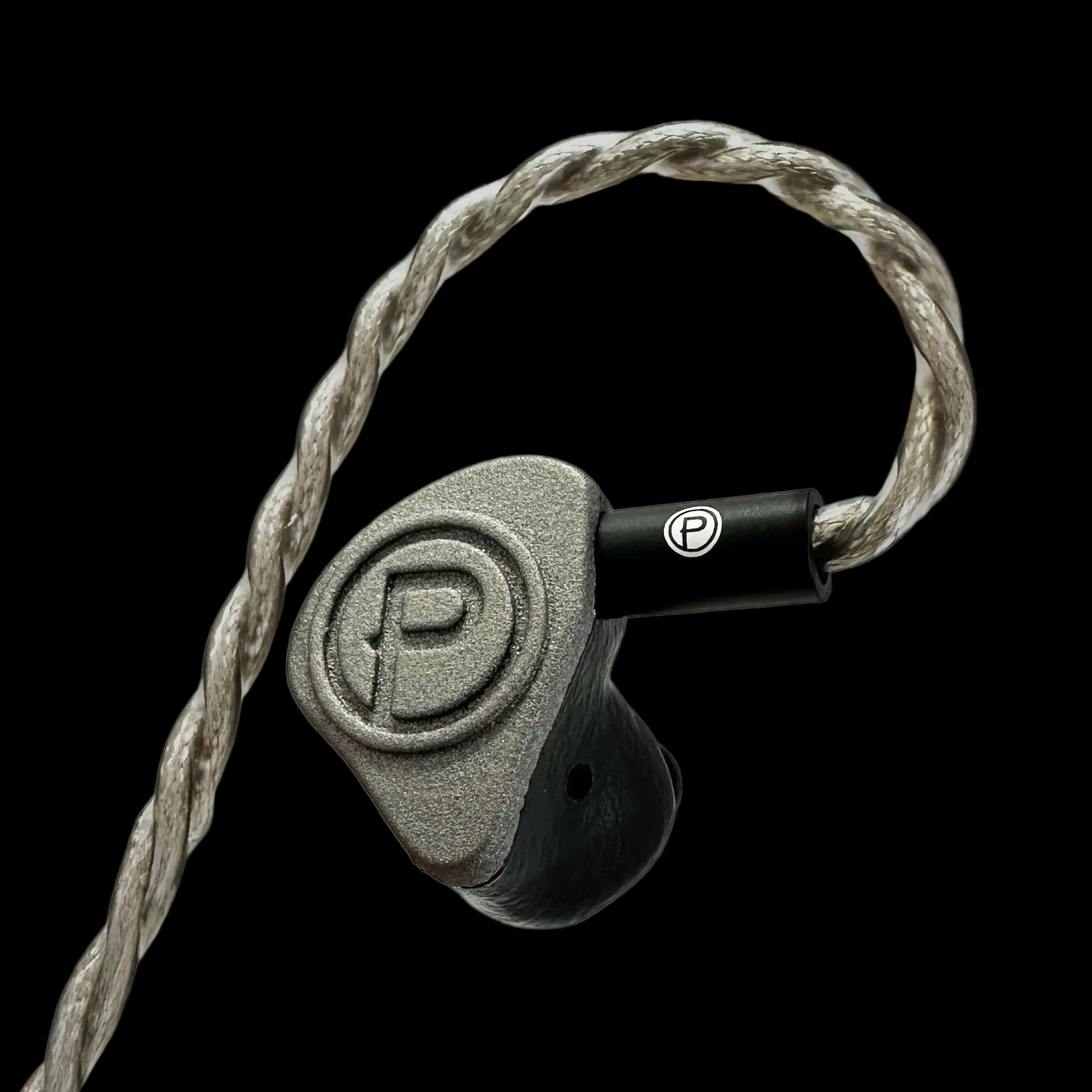 In-ear monitor with braided cable on a black background