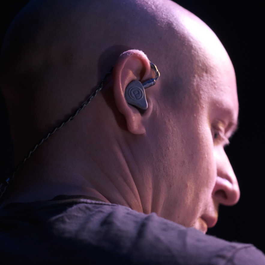 Profile of bald man wearing Plunge Audio IEMs.