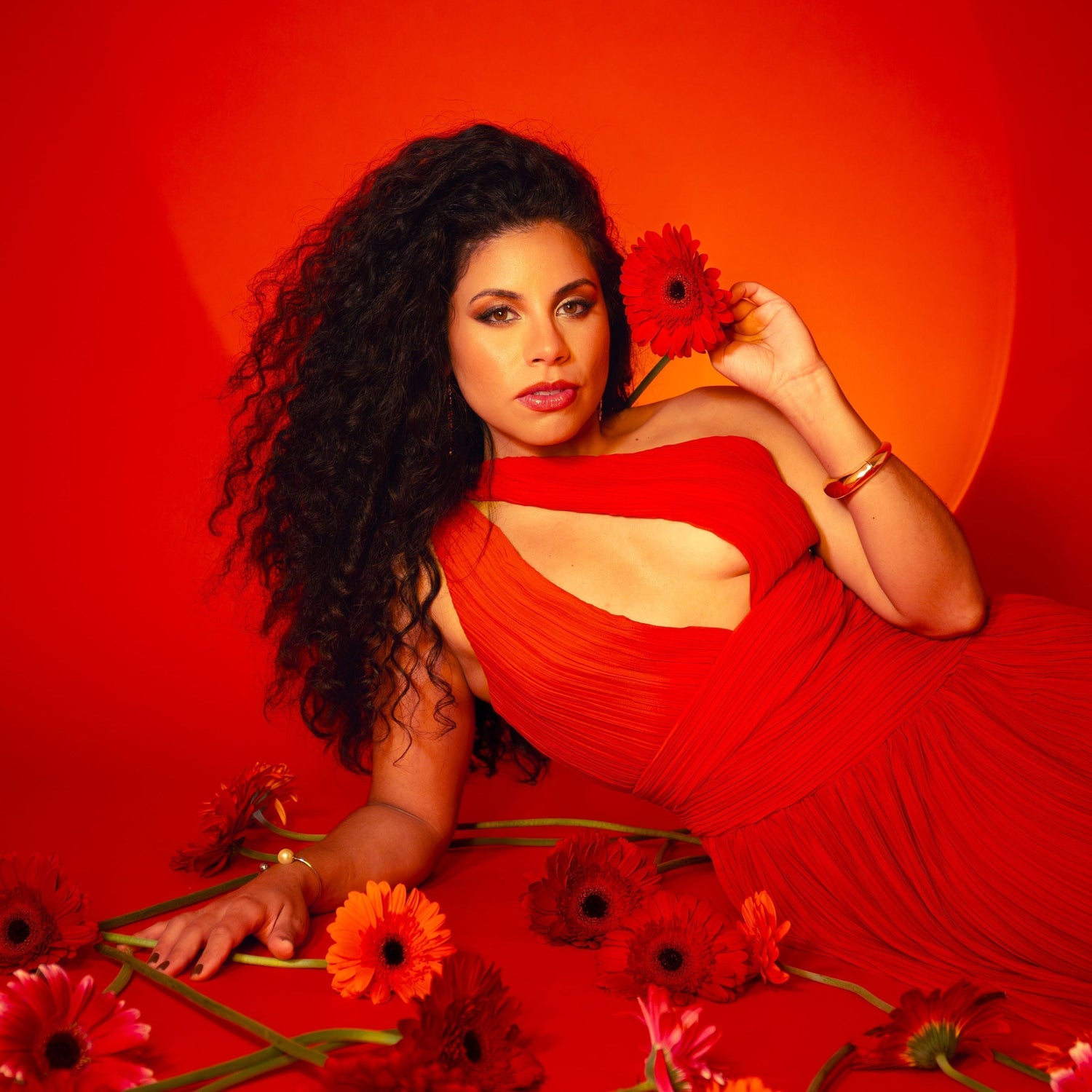Singer Lussilia dressed in red with red backdrop.