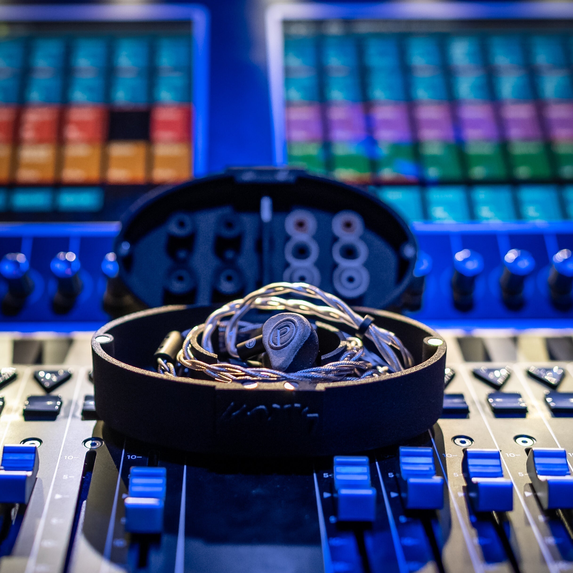 Open IEM case resting on tech's audio console.