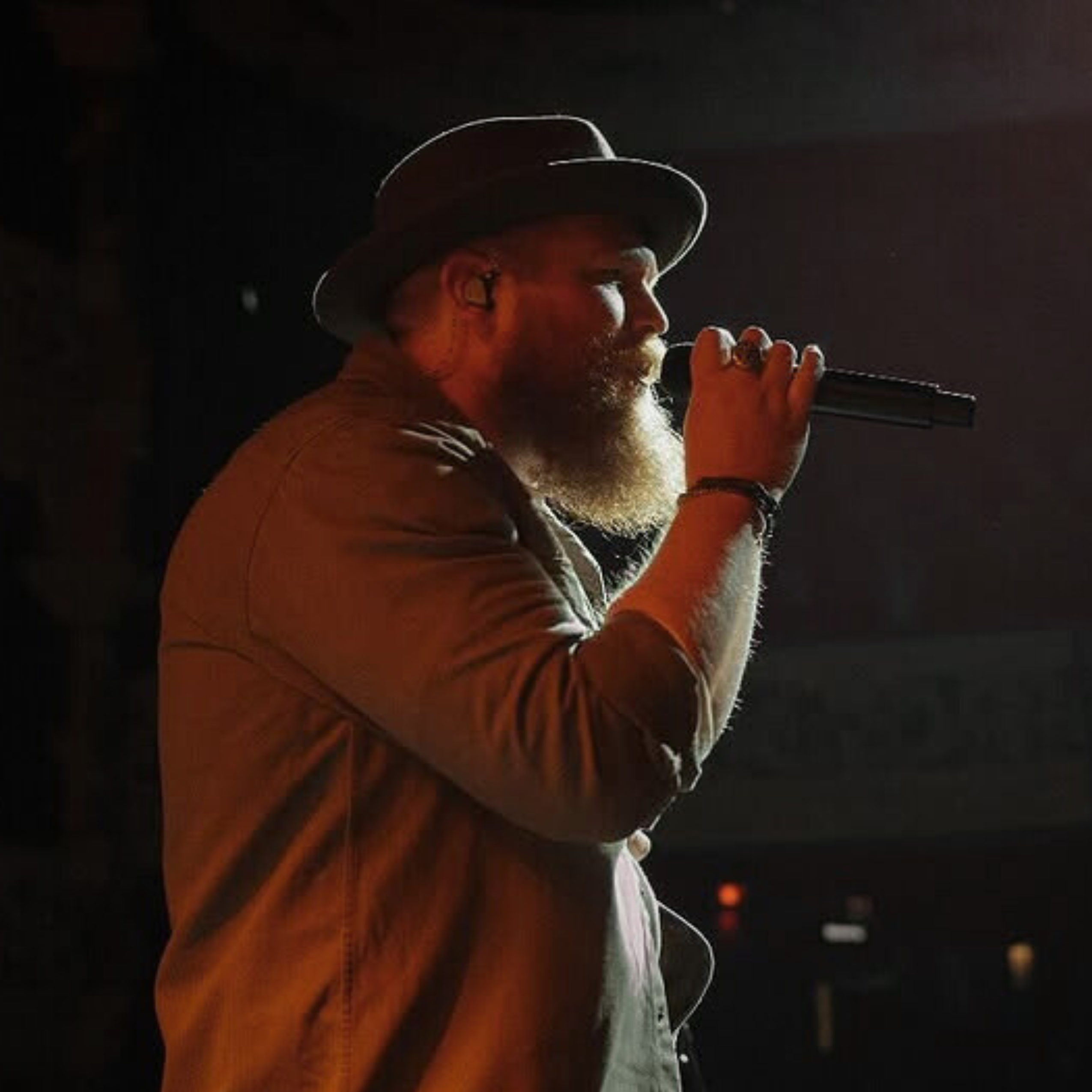 Tyler Braden wearing Unity IEMs sings into a mic.