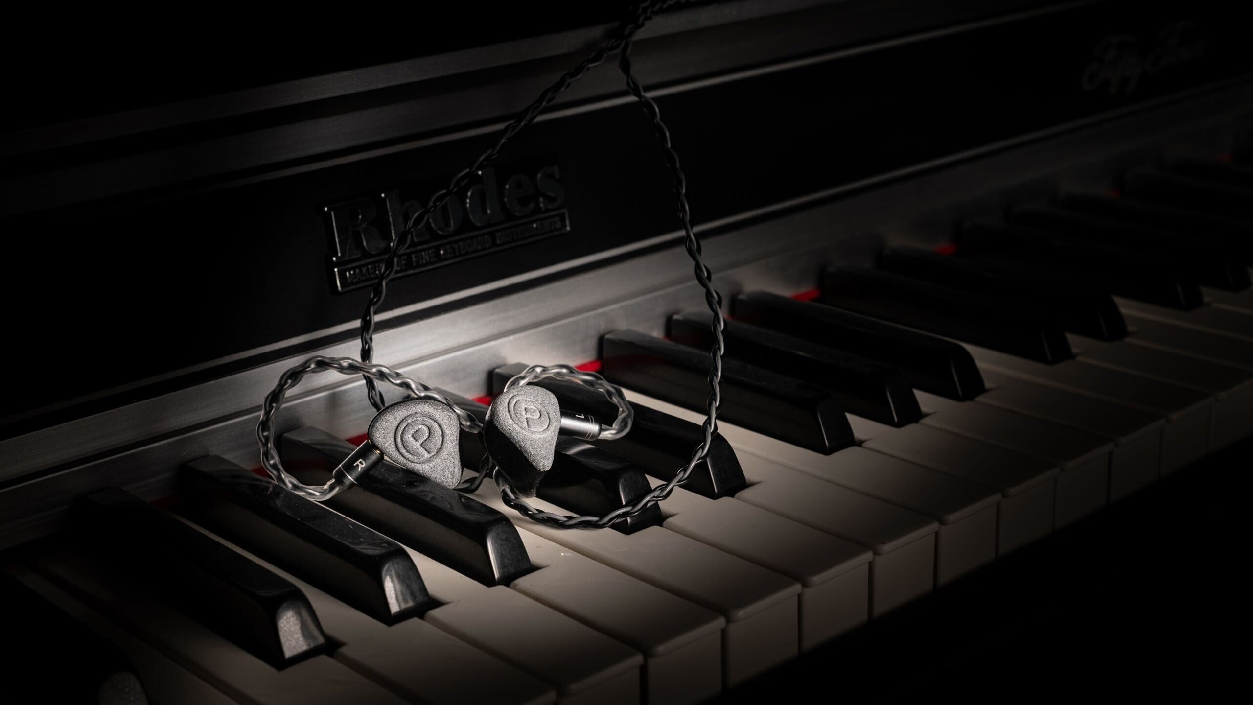 Unity IEMs resting on piano keys.