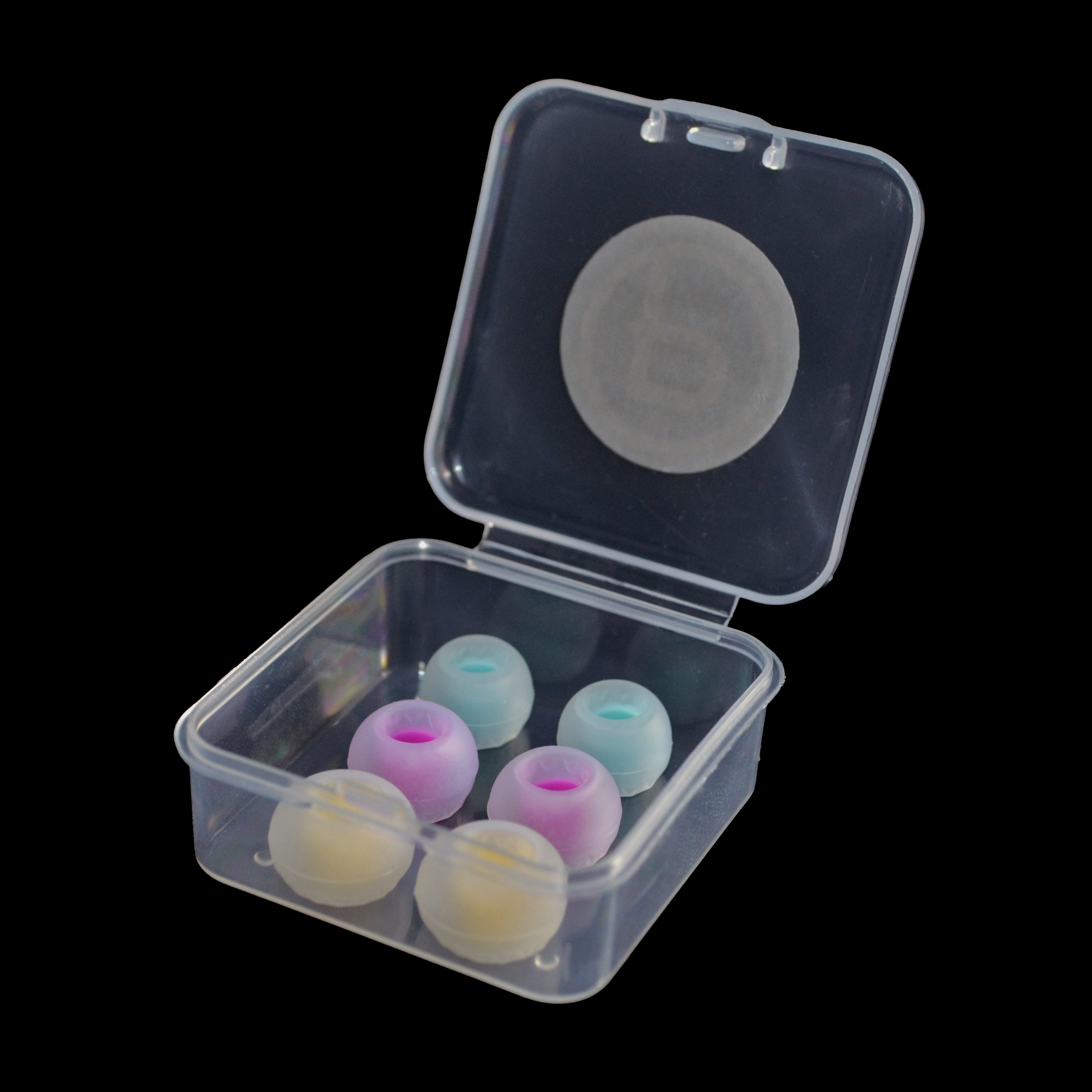 Clear plastic container with colourful IEM tips on a black background.