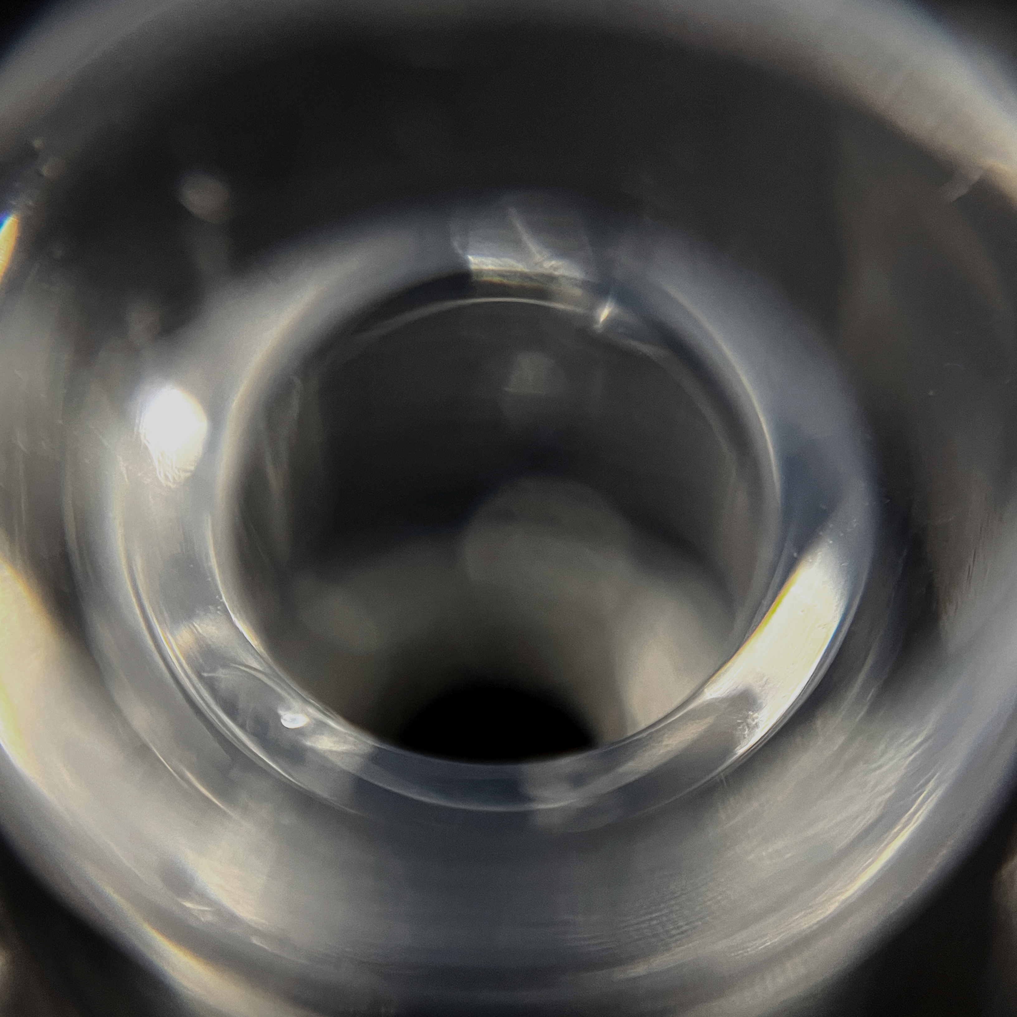 Close-up of clear IEM tip with reflective surface.