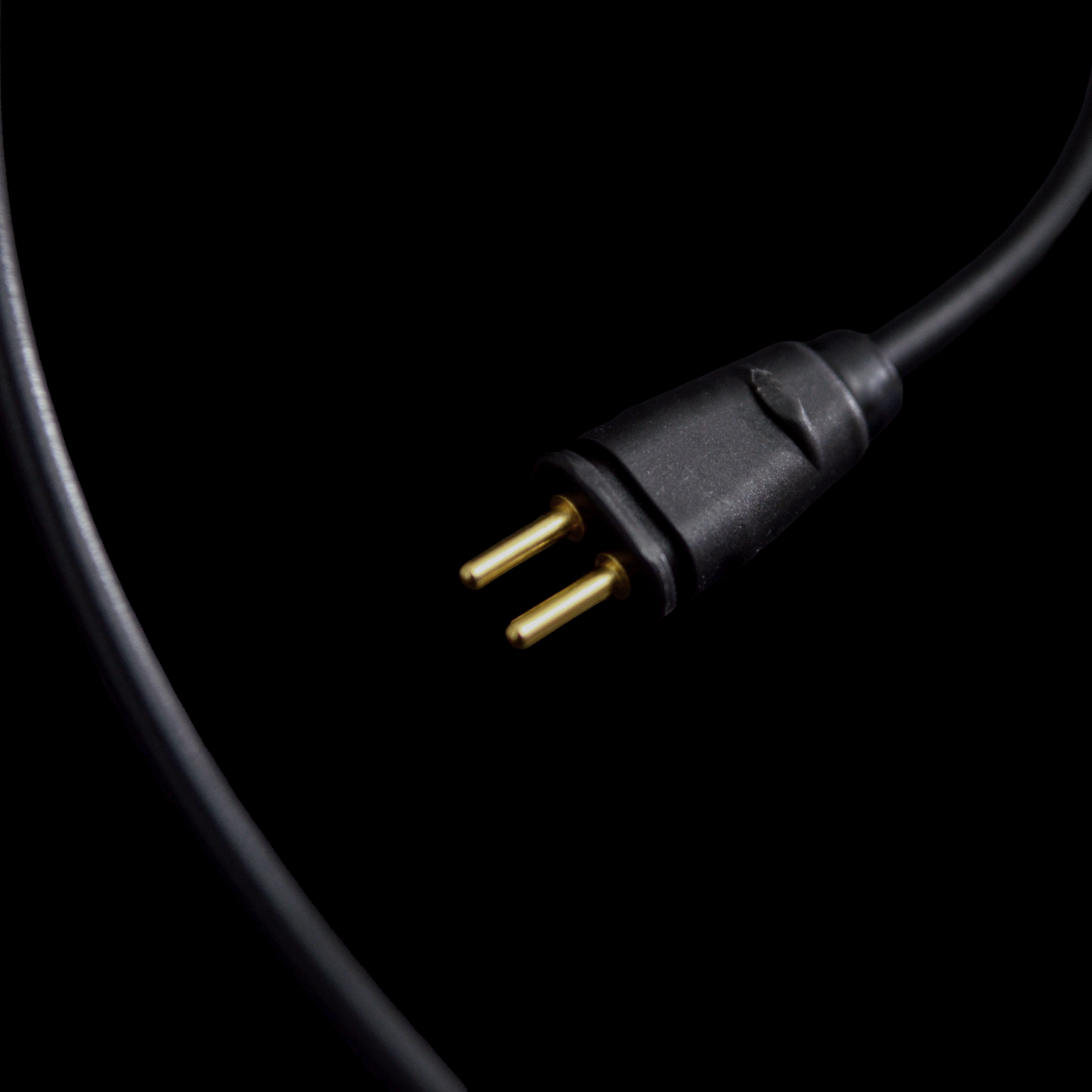 Black 2-pin plug on a black background