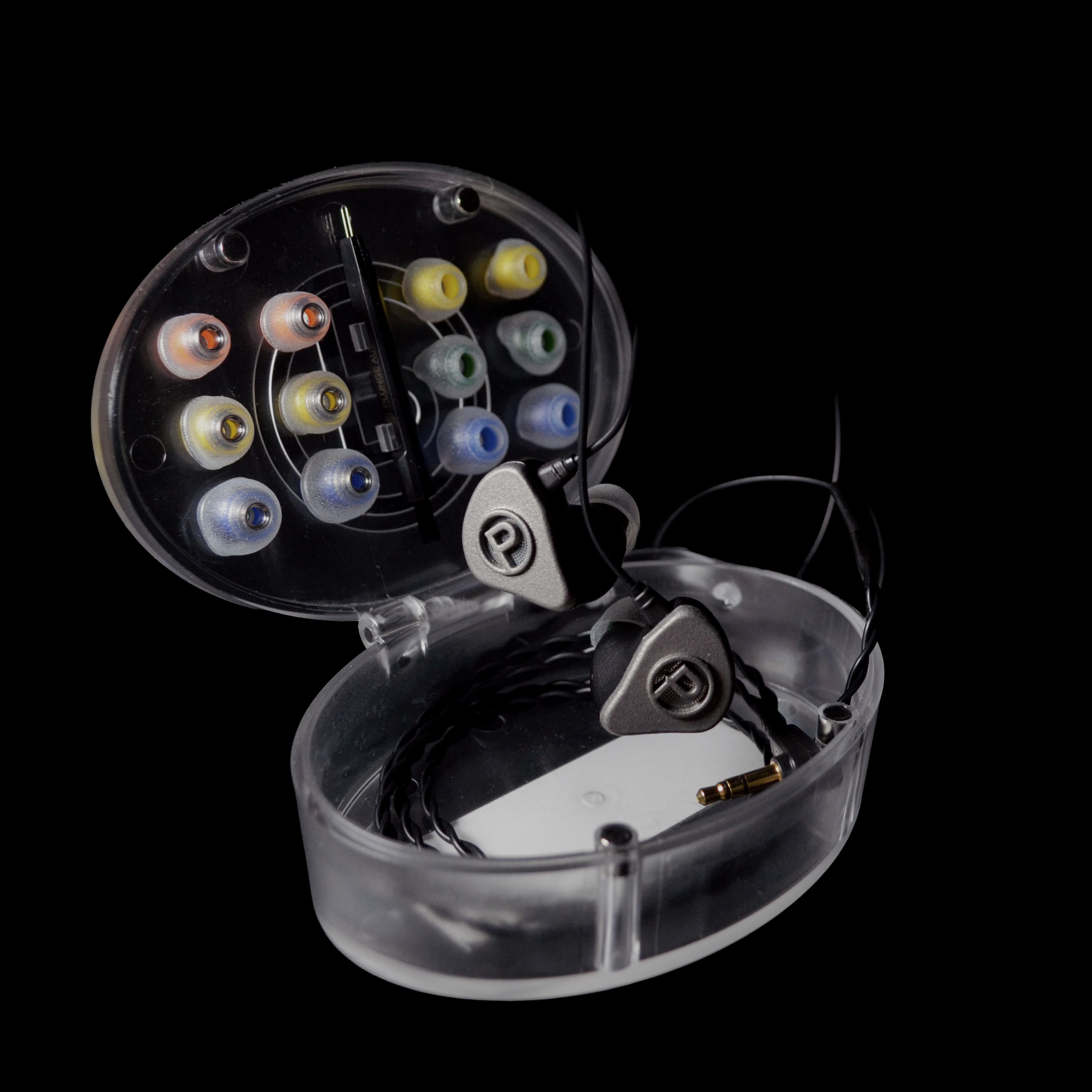 Close-up of a transparent IEM case with coloured tips and IEMs on a black background.