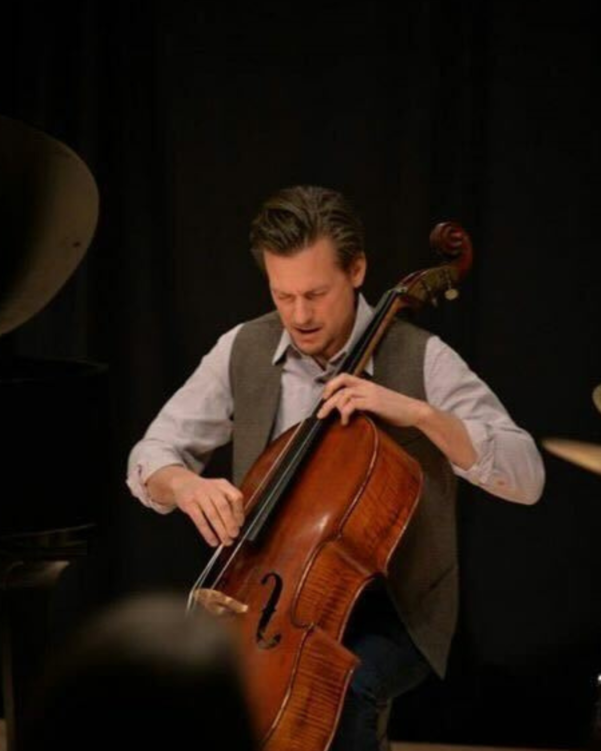 Simon Fisk playing upright bass with his eyes closed.