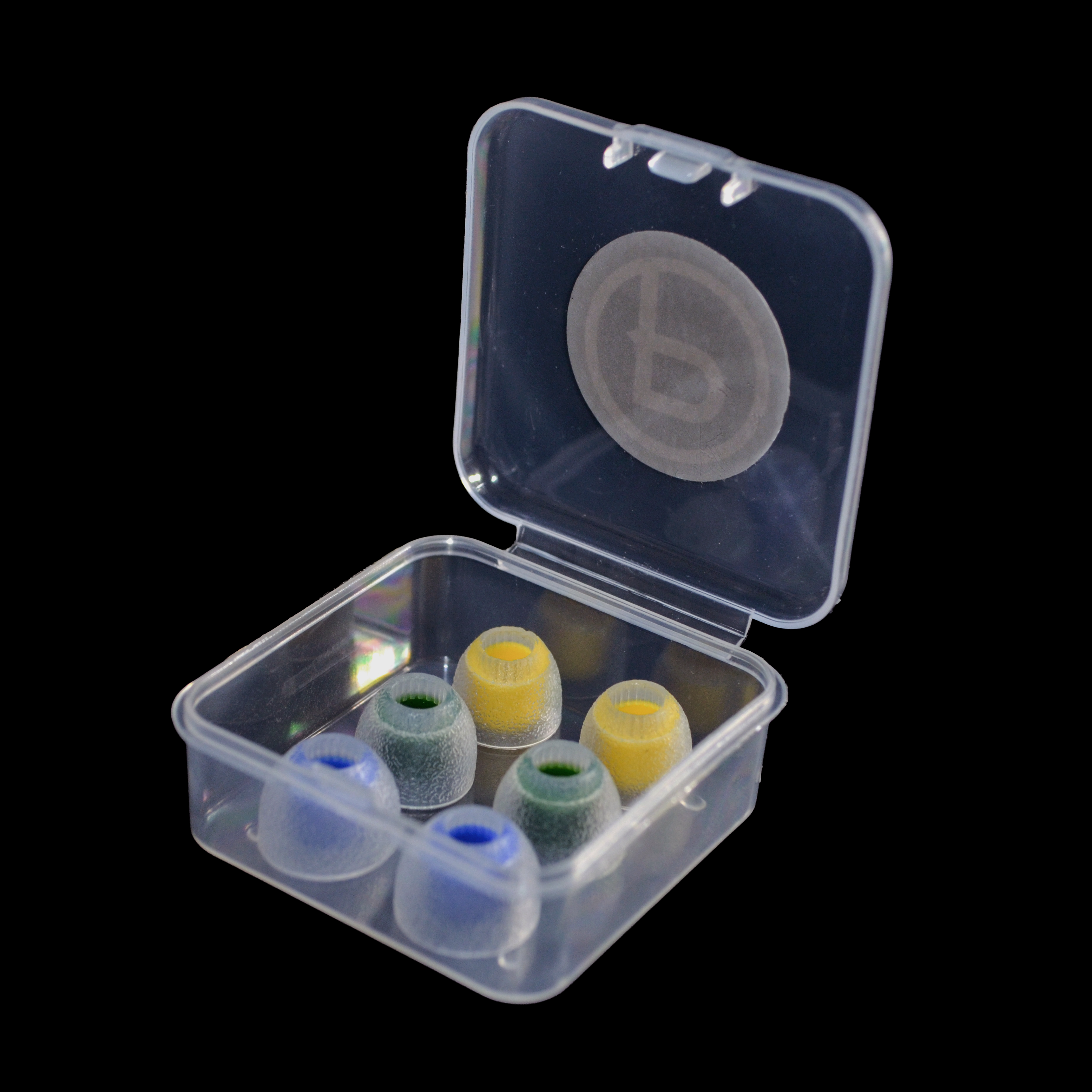Clear plastic container with colorful IEM tips on a black background