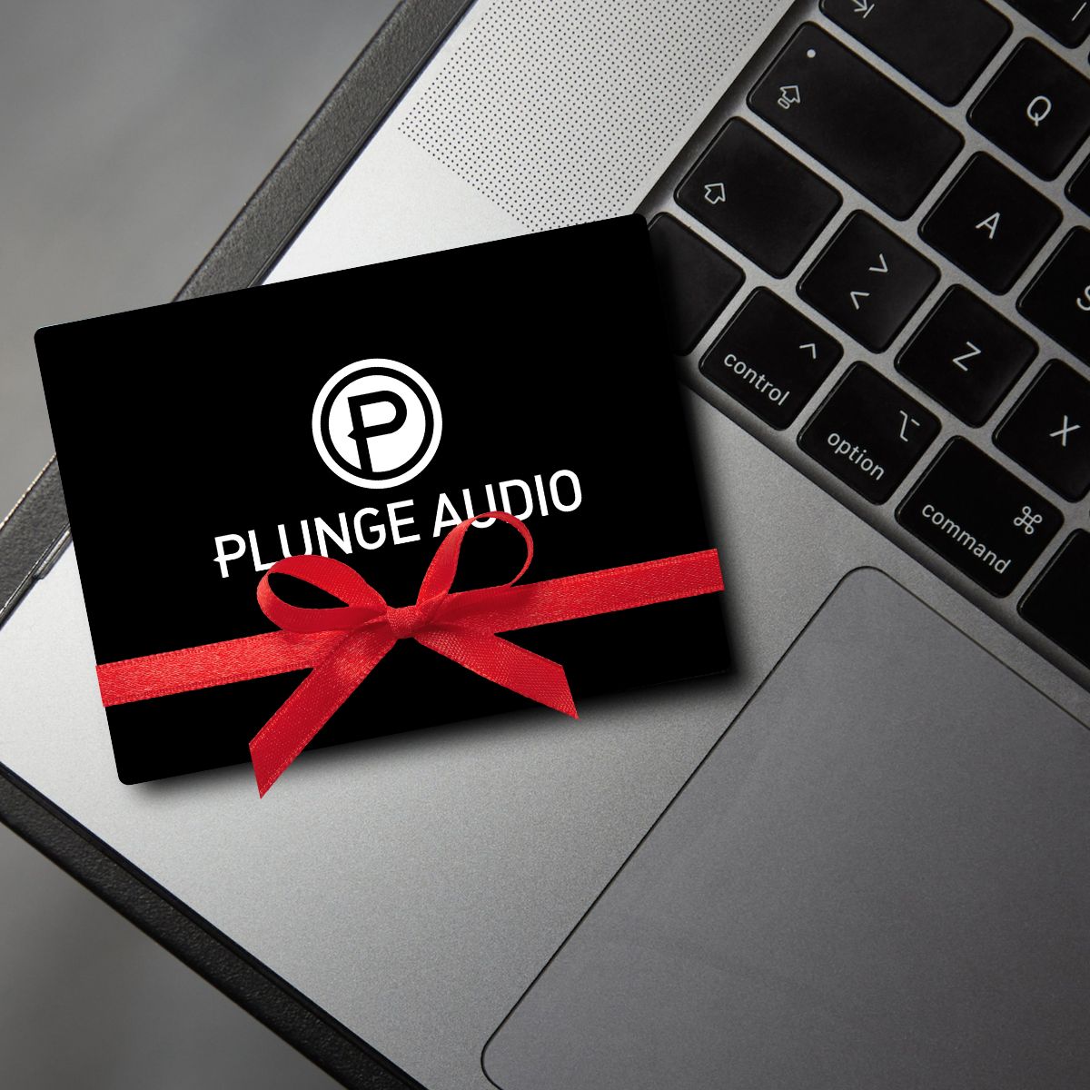 Black Plunge Audio gift card resting on computer.