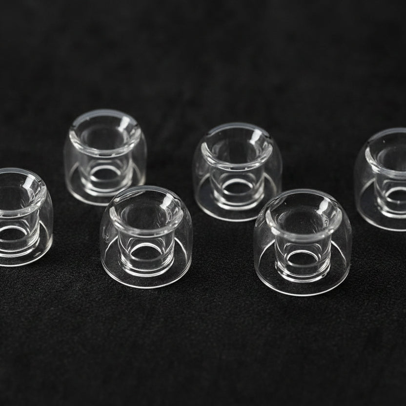 Set of clear IEM tips on a gray surface